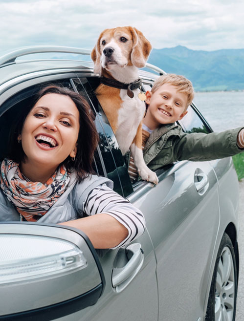 Happy family in a car who saved on auto insurance using Save Max Auto